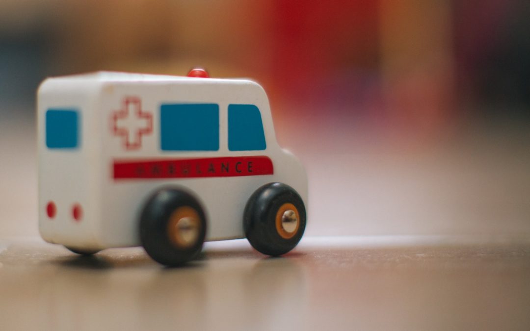 a toy ambulance is sitting on the floor